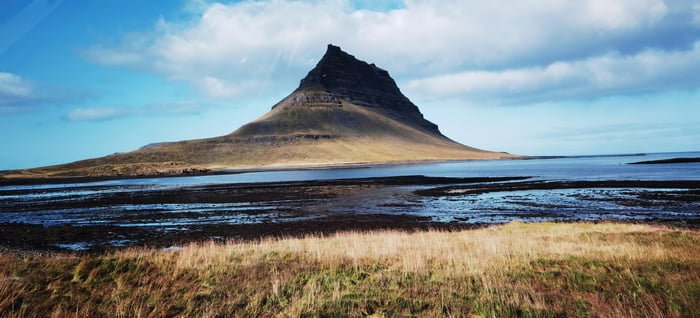 Mount Kirkjufell in Iceland with a body of water