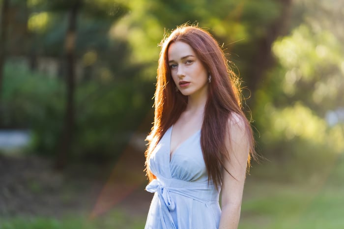 Woman with red hair in a light blue dress