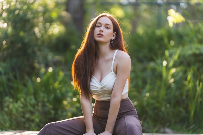 Girl with long red hair in a white top