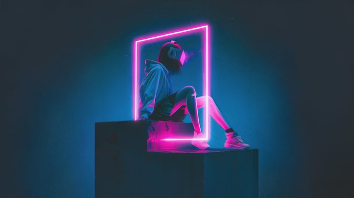 Person in VR headset sitting in neon light