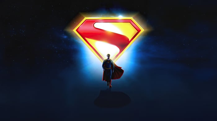 Superman in front of the Superman logo