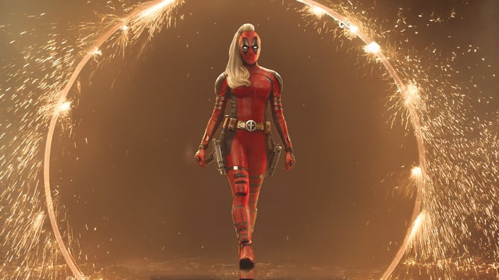 Lady Deadpool walks through a ring of sparks