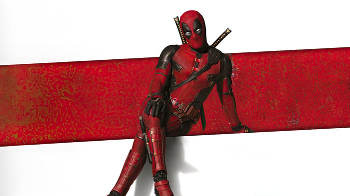 Deadpool sitting on a red and white background