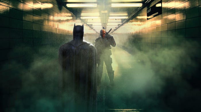 Batman and Deathstroke in a subway tunnel