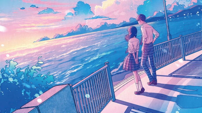 Couple Watching the Sunset Over the Ocean