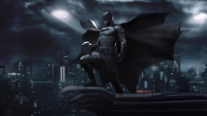 Batman on a rooftop overlooking Gotham City