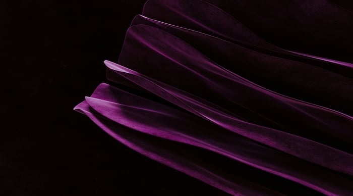 Abstract purple fabric flowing against black background