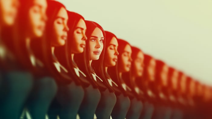 Multiple women in a line with red and yellow lighting