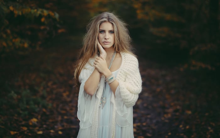 Woman with long blonde hair in a forest