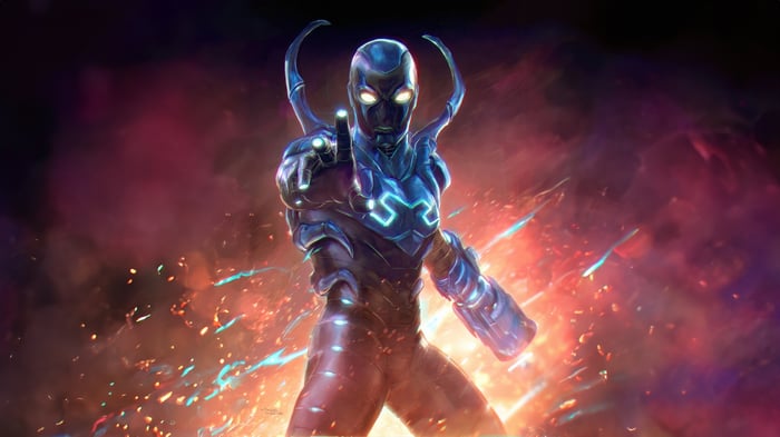 Blue Beetle in a bold stance with fiery background