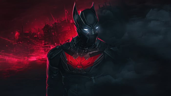 The Batman in a dark, red-lit city