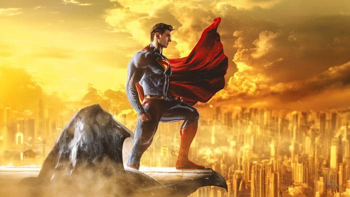 Superman standing on a gargoyle overlooking a city