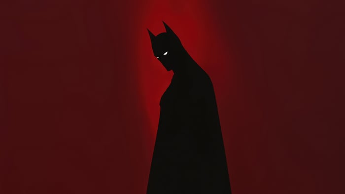 Batman silhouette against a red background