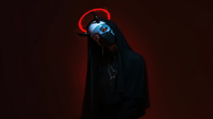 Nun with devil horns and red halo
