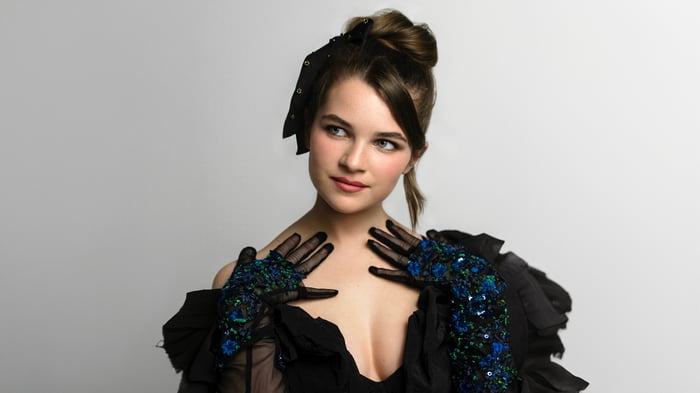Raegan Revord in a black dress and gloves