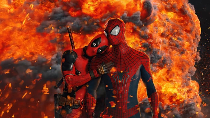 Deadpool and Spider-Man embrace in front of an explosion