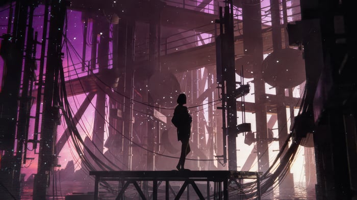 Silhouette of a person standing on a platform in a futuristic industrial zone.