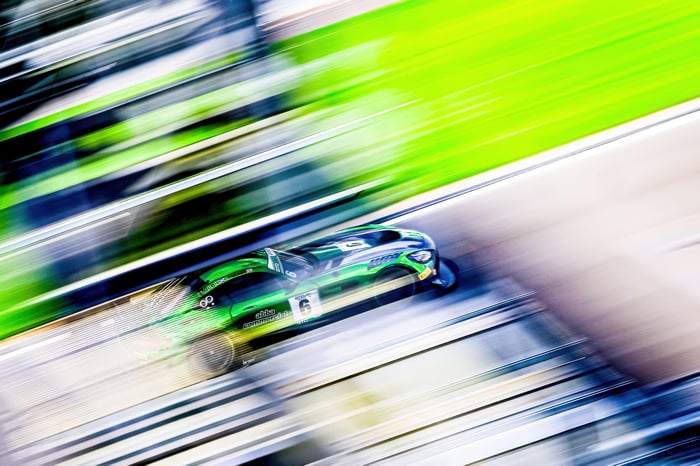 Green Mercedes AMG GT3 race car on a track