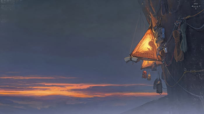 Girl camping on a mountain at sunset