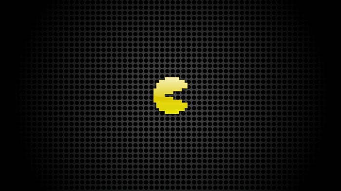 Pac-Man on a dark perforated background
