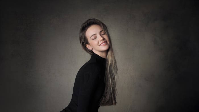 Cute girl with closed eyes wearing a black turtleneck