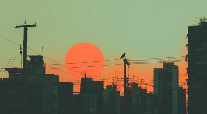 Bird on a wire with a large sun and city skyline