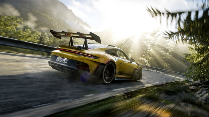 Yellow Porsche 911 GT3 RS driving on a mountain road