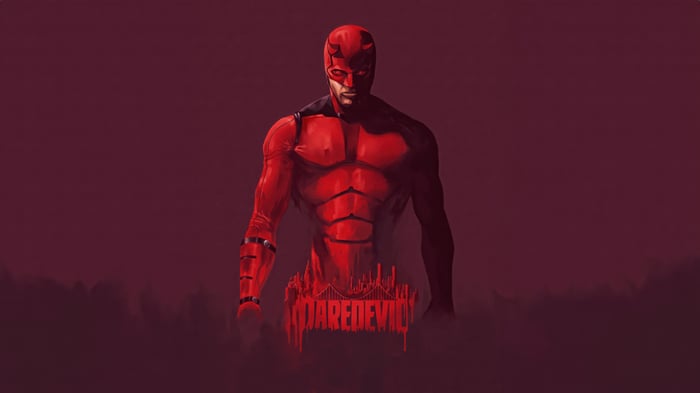 Daredevil in a red suit with a city skyline