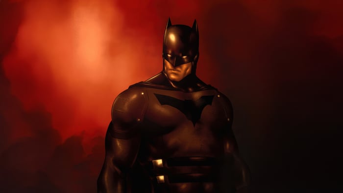 Batman in a dark suit with a red background