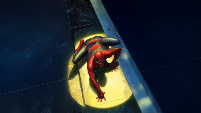 Spiderman climbing on a building at night