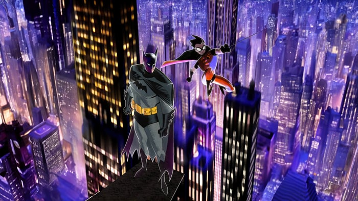Batman and Robin overlooking a city at night