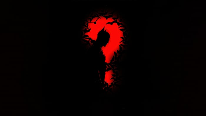 Batman silhouette against a red question mark