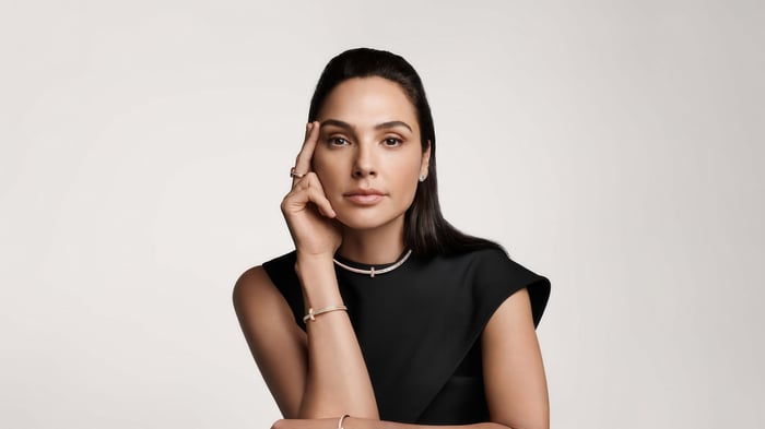Gal Gadot wearing a black dress and jewelry