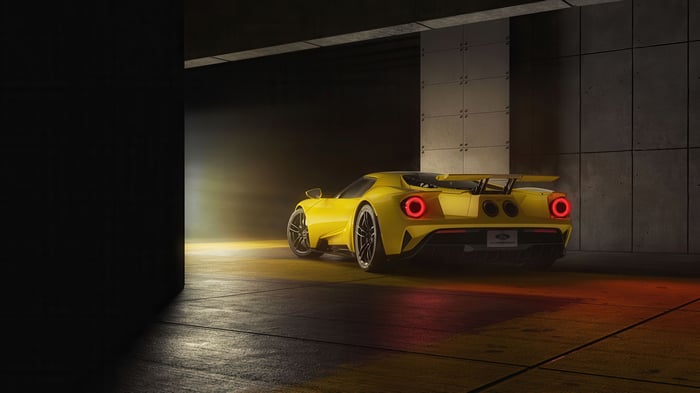 Yellow Ford GT 2024 in a dark garage