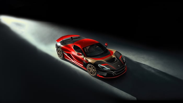 Red Rimac Nevera sports car in spotlight