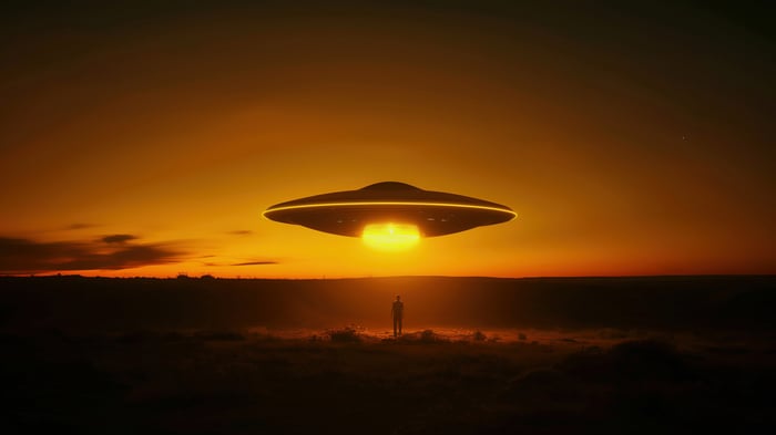 UFO hovering over a person at sunset