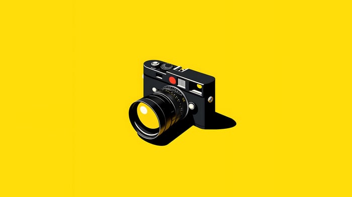Minimalist illustration of a black camera on a yellow background