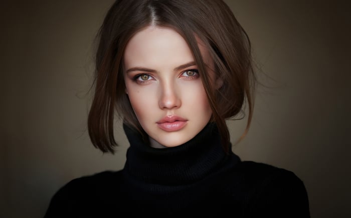 Woman with brown hair wearing a black turtleneck