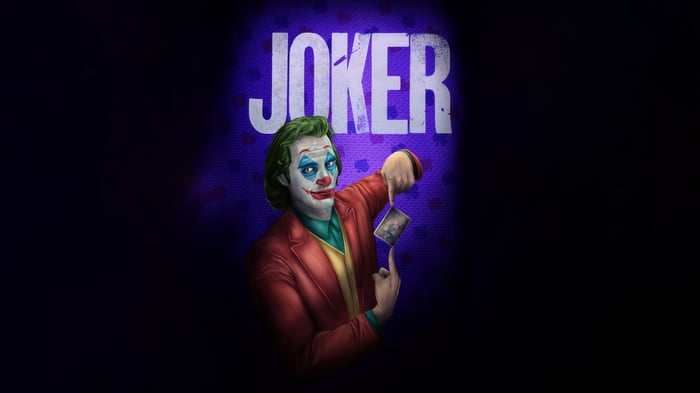 Joker holding a playing card