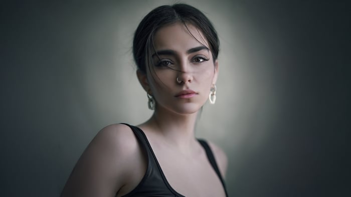 Girl with nose piercing and large earrings