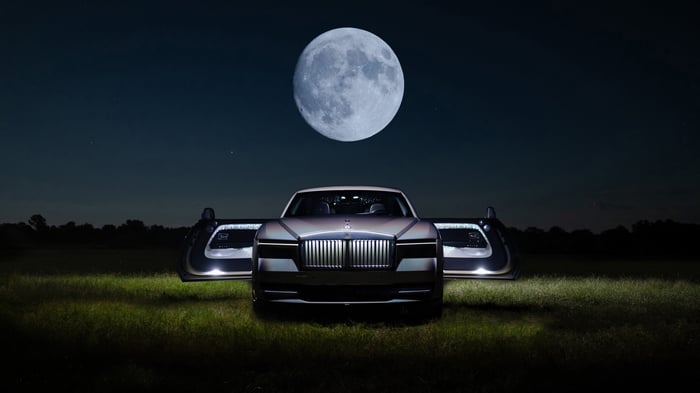 Rolls Royce Spectre with doors open under the moon
