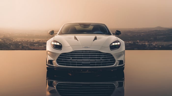 White Aston Martin Vanquish 2024 on reflective surface