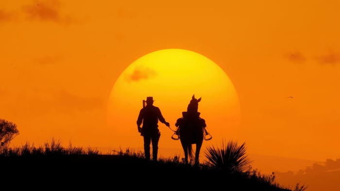 Red Dead Redemption 2 silhouette of man and horse at sunset