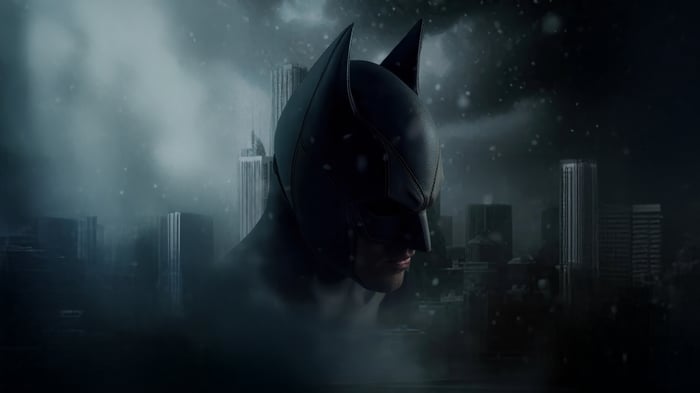 Batman in a snowy city at night