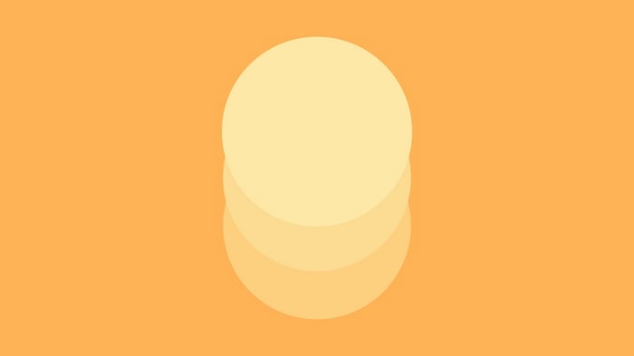 Stack of pastel yellow circles on orange background