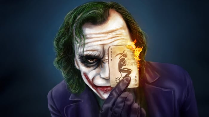 The Joker holding a burning playing card