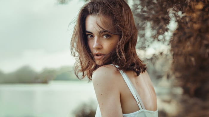 Girl in white dress looking over shoulder