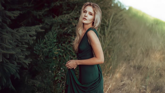 Woman in a green dress in the woods