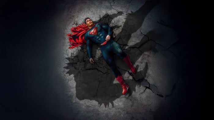 Superman lying on cracked ground