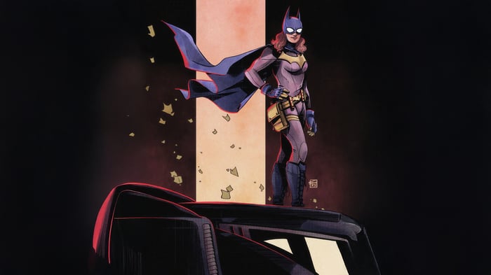Batgirl standing on a vehicle